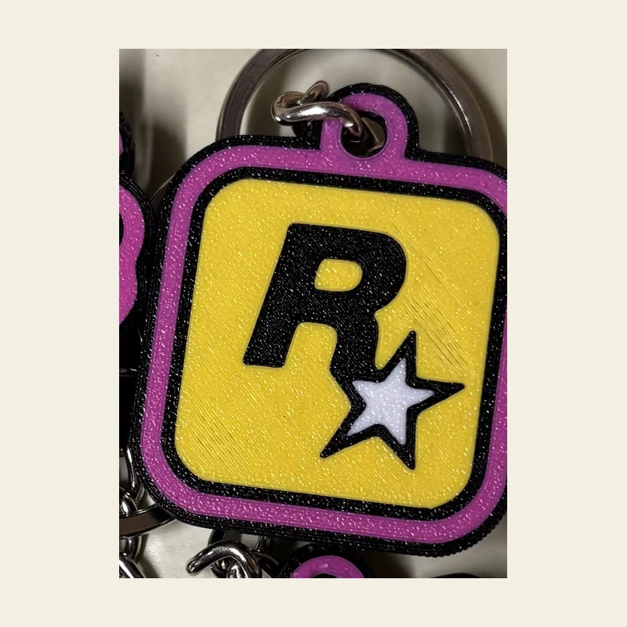 Porte-clés Rockstar Games en relief rose et jaune